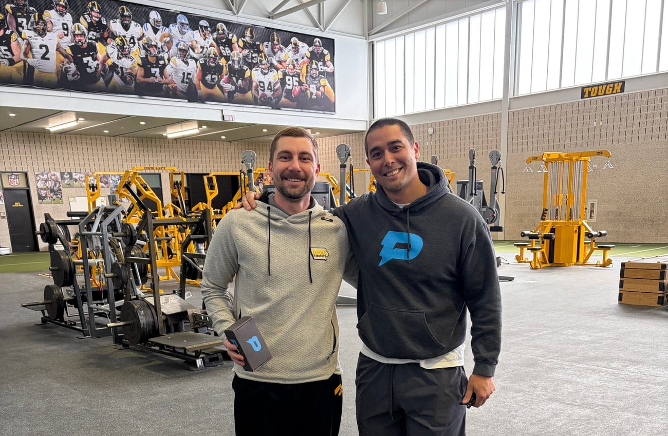 Kohle Helle holding a Plyomat at the Iowa Football facility